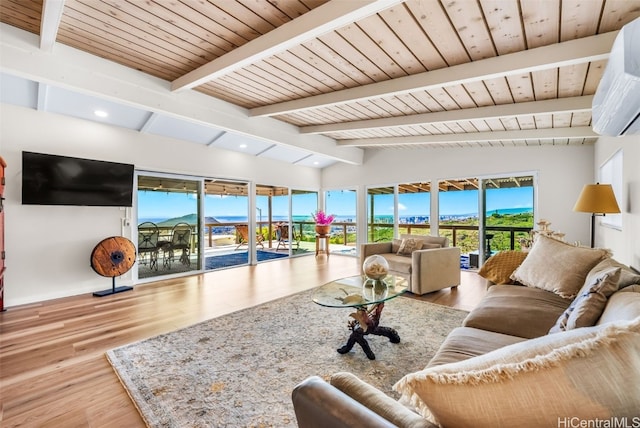 living room featuring an AC wall unit, a wealth of natural light, light hardwood / wood-style floors, and vaulted ceiling with beams