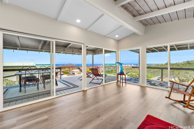 unfurnished sunroom with lofted ceiling with beams