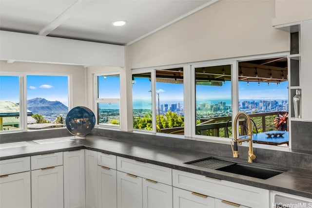 kitchen featuring white cabinetry, sink, and a mountain view