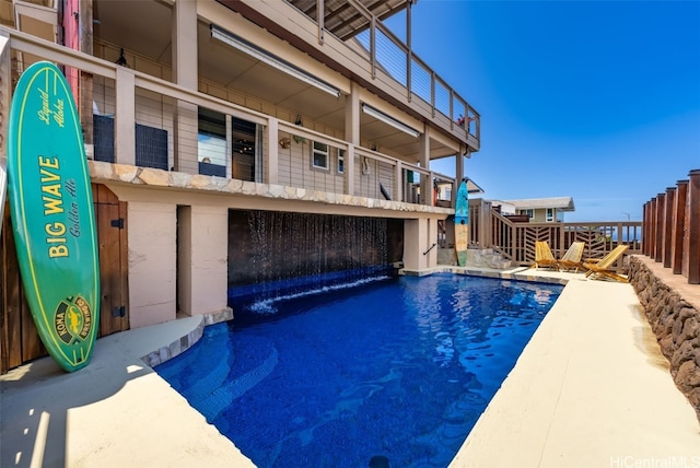 view of swimming pool with pool water feature