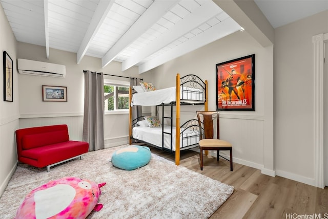 bedroom featuring wood ceiling, beam ceiling, light hardwood / wood-style floors, and an AC wall unit