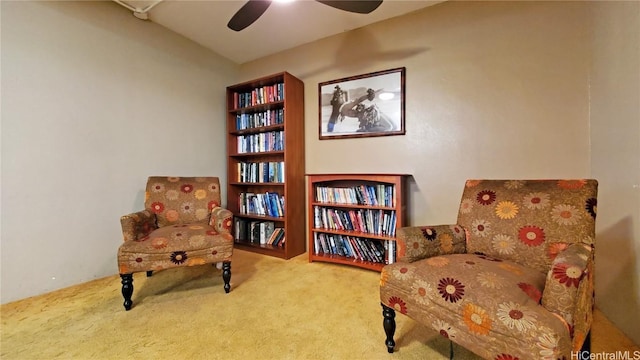 living area with carpet flooring and ceiling fan