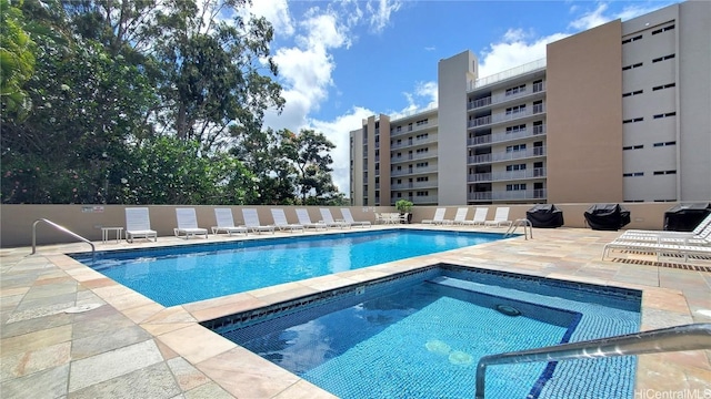 view of pool featuring a hot tub and a patio