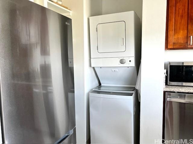 laundry room with stacked washer / drying machine