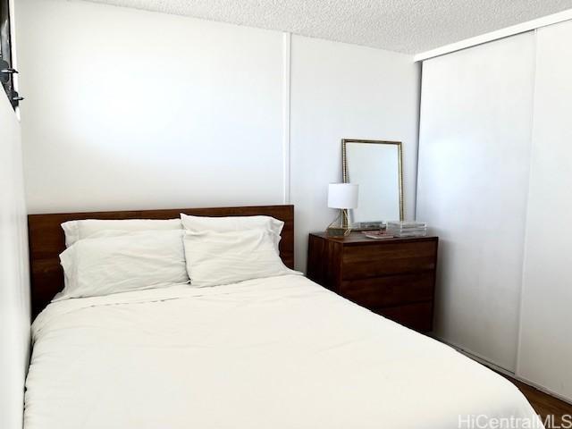 bedroom featuring a closet and a textured ceiling