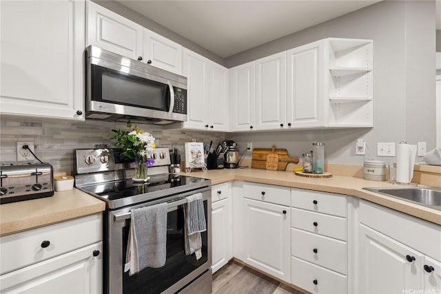 91-338 Makalea St Unit 52, Ewa Beach, HI 96706 - kitchen featuring appliances with stainless steel finishes, white cabinetry, tasteful backsplash, and light countertops