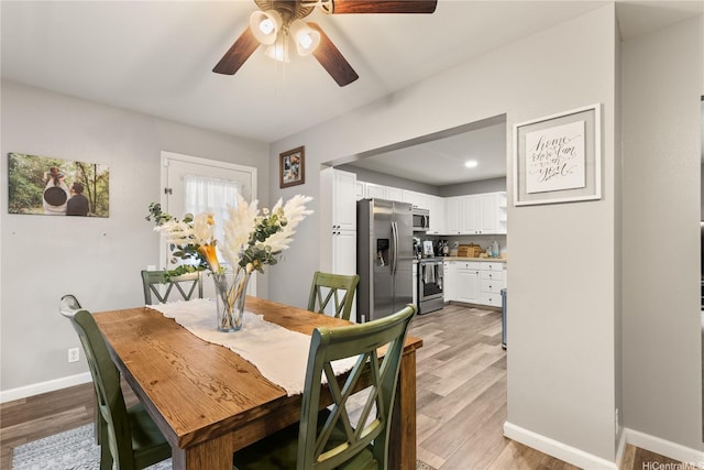 91-338 Makalea St Unit 52, Ewa Beach, HI 96706 - dining area with light wood-style flooring and a ceiling fan