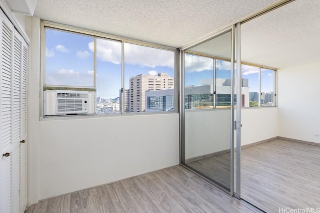 unfurnished sunroom featuring cooling unit