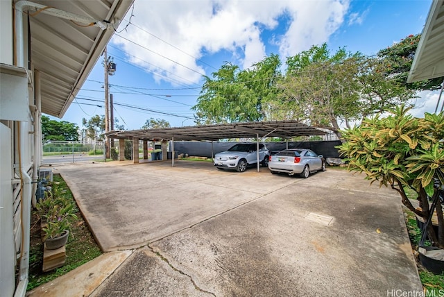 view of parking / parking lot featuring fence