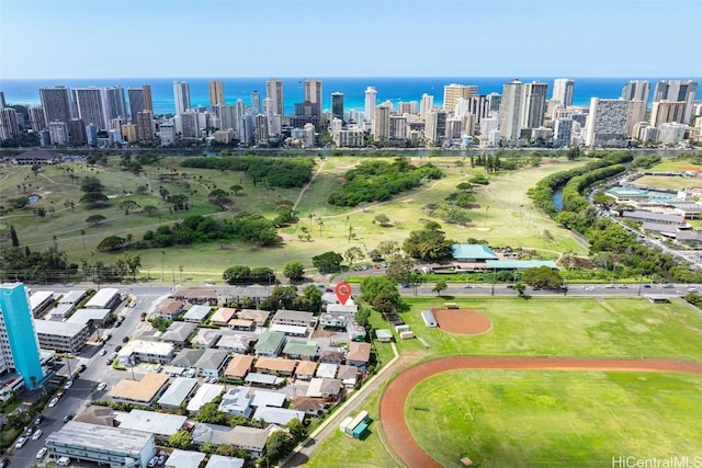 birds eye view of property featuring a water view and a city view