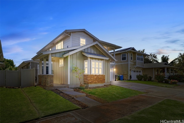 view of front of home with a yard and a garage