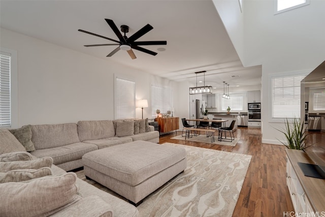 living room featuring hardwood / wood-style flooring and ceiling fan