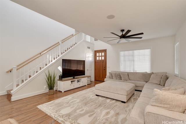 living room with ceiling fan and light wood-type flooring