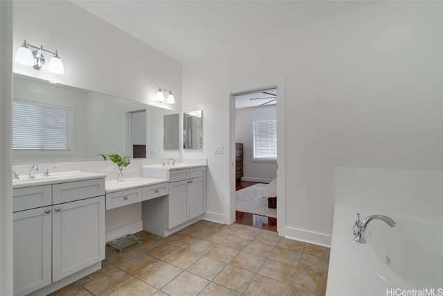 bathroom featuring vanity and a tub