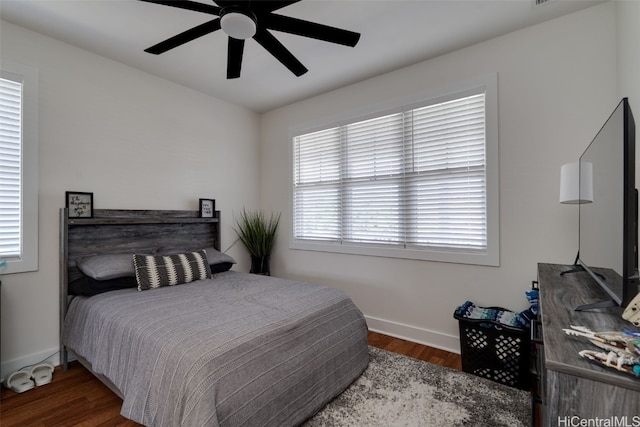 bedroom with dark hardwood / wood-style floors and ceiling fan