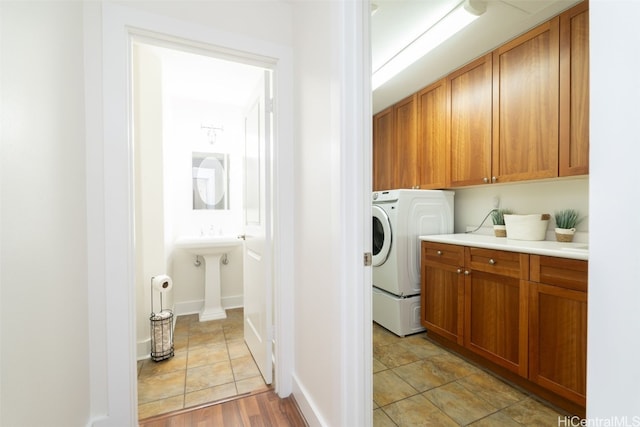 laundry area with washer / clothes dryer and cabinets