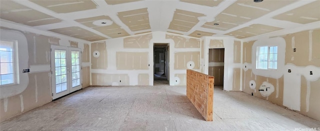 empty room featuring a healthy amount of sunlight and french doors