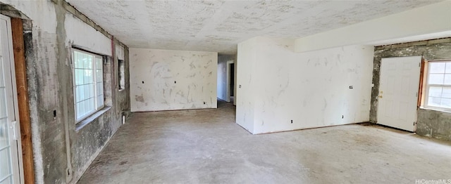 empty room featuring unfinished concrete flooring