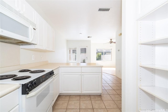 kitchen featuring light tile patterned flooring, white cabinetry, ceiling fan, kitchen peninsula, and white appliances