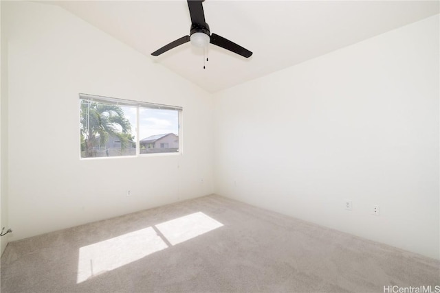 carpeted empty room featuring lofted ceiling and ceiling fan