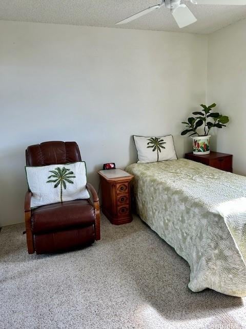 bedroom with ceiling fan, carpet flooring, and a textured ceiling