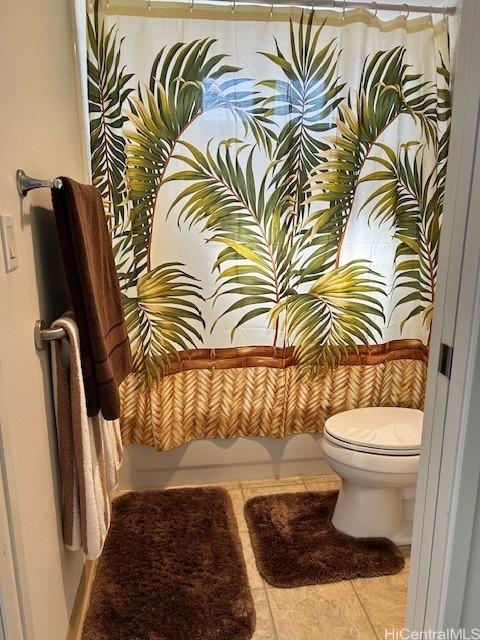 bathroom with tile patterned flooring and toilet