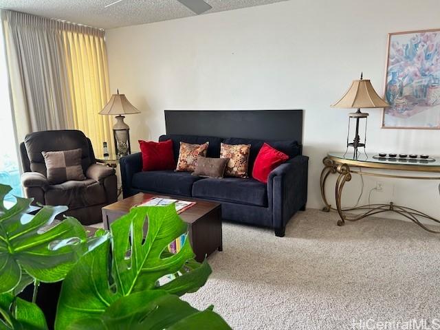 living room featuring carpet flooring and a textured ceiling