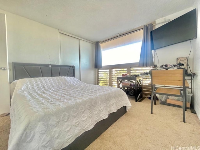 bedroom with light carpet and a closet