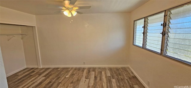 unfurnished bedroom featuring dark wood-type flooring, a closet, and ceiling fan