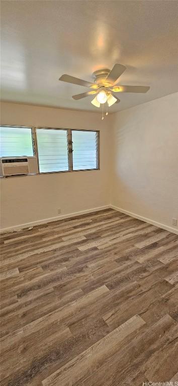 spare room featuring ceiling fan, dark hardwood / wood-style flooring, and a wealth of natural light