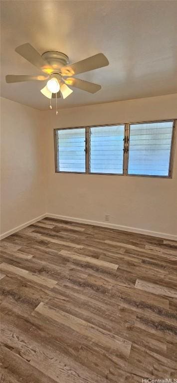 unfurnished room with ceiling fan and dark hardwood / wood-style flooring