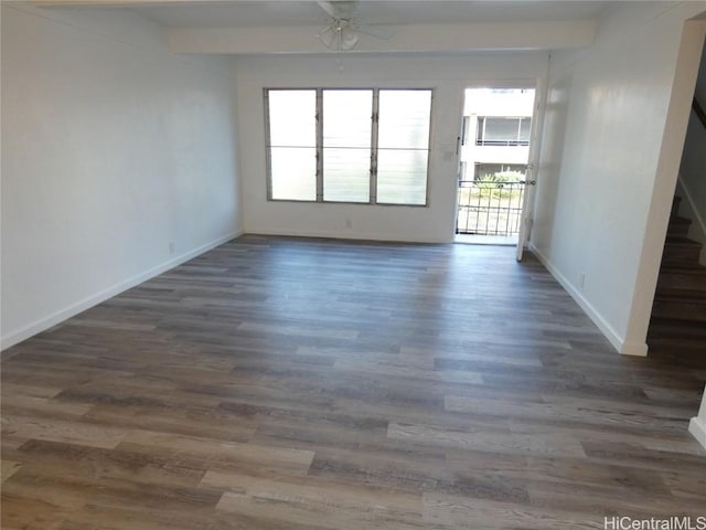 unfurnished room with ceiling fan and dark hardwood / wood-style flooring