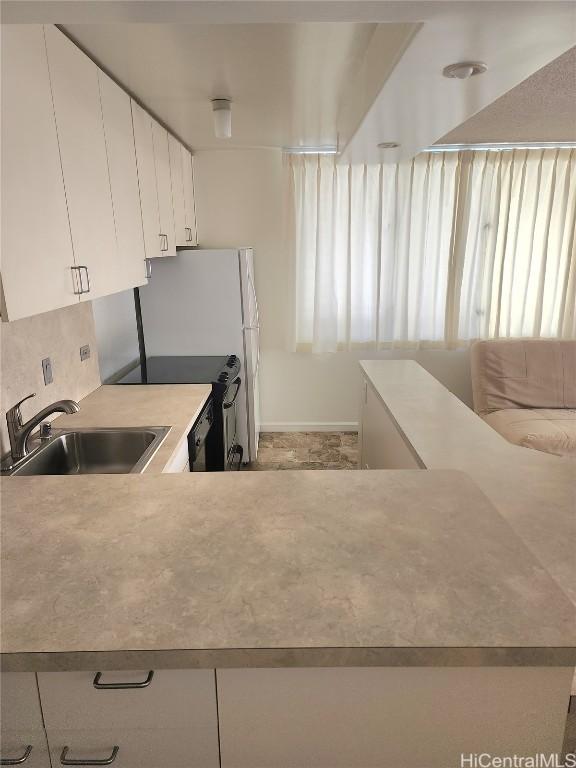 kitchen with white cabinetry, a healthy amount of sunlight, and sink