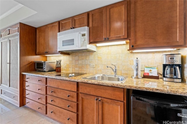 kitchen featuring sink, light tile patterned floors, backsplash, black appliances, and light stone countertops