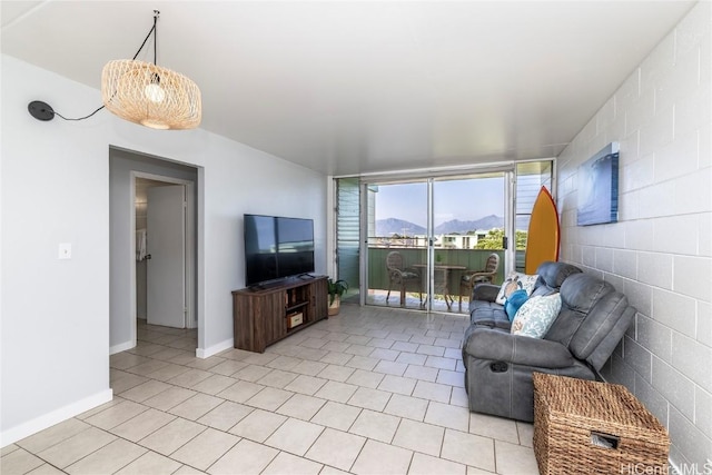 living area featuring baseboards and light tile patterned floors