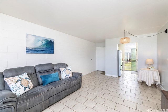 living room featuring baseboards and light tile patterned floors