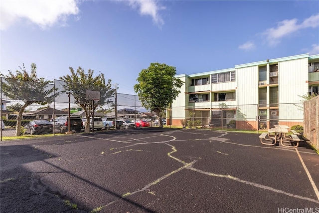 exterior space with community basketball court and fence