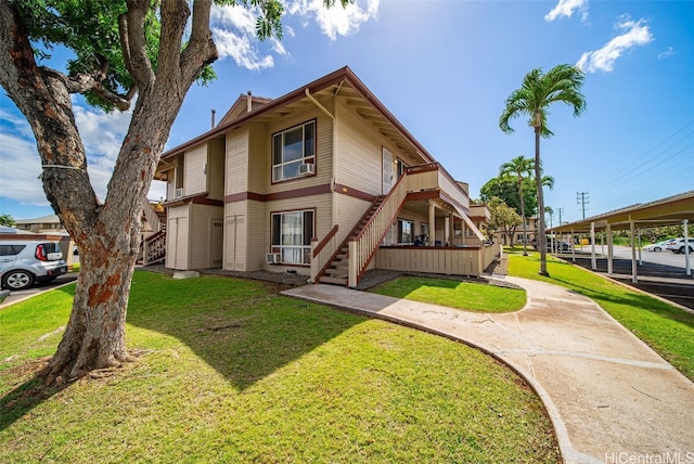 townhome / multi-family property with a front yard and stairway