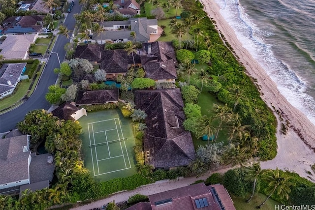 birds eye view of property with a water view and a beach view