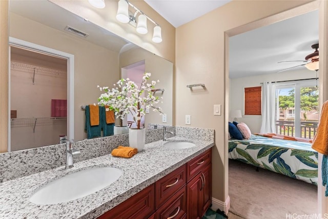 full bath with a sink, visible vents, connected bathroom, and a ceiling fan