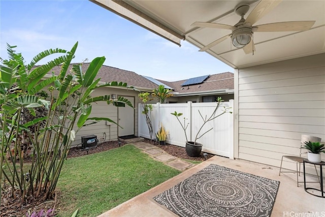 view of yard featuring a patio, a ceiling fan, and fence