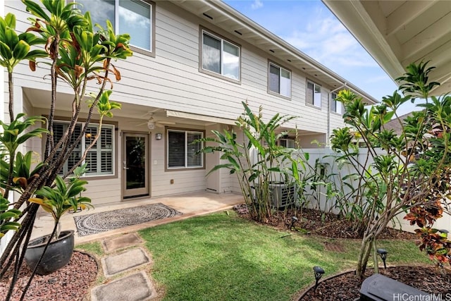 back of house featuring a yard, a patio, ceiling fan, and fence