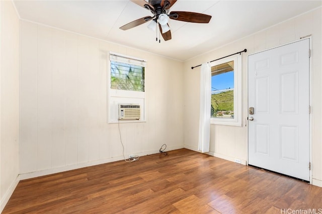 spare room with cooling unit, hardwood / wood-style flooring, and ceiling fan