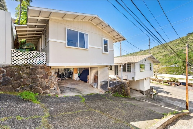 rear view of house featuring a carport