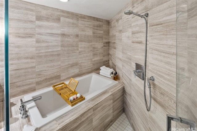 bathroom with a tile shower and a bath