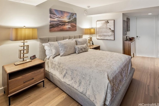 bedroom with hardwood / wood-style floors