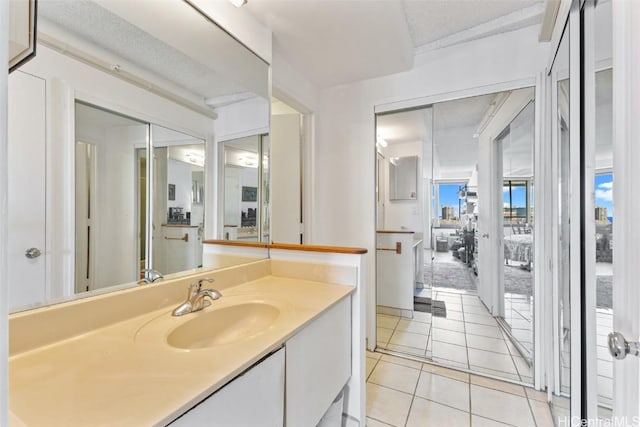 bathroom with tile patterned floors and vanity