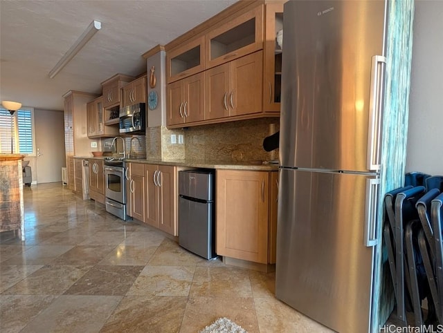 84-965 Farrington Hwy Unit A604, Waianae, HI 96792 - kitchen with light stone counters, stainless steel appliances, and backsplash