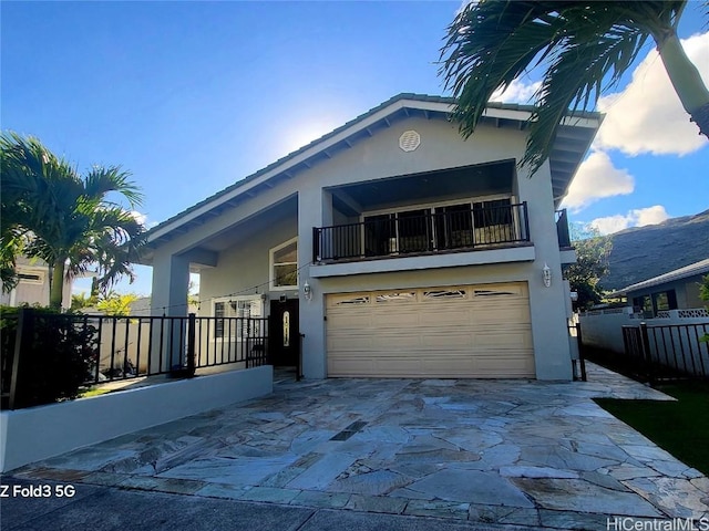 view of front of house with a garage and a balcony