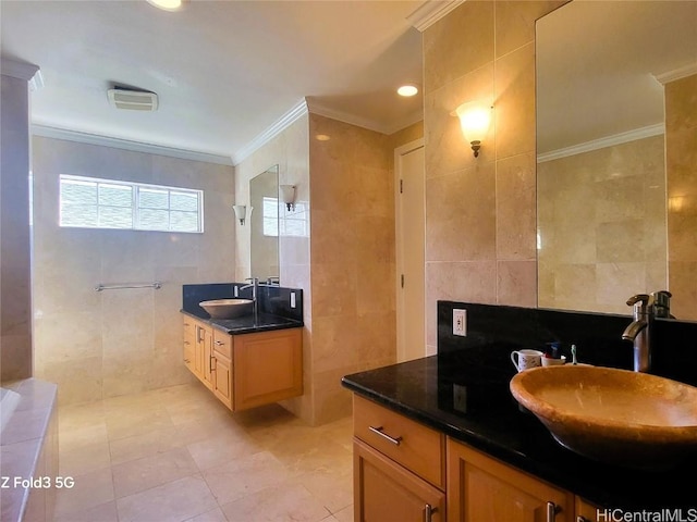 bathroom featuring tile walls, vanity, crown molding, and tile patterned flooring